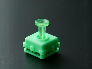 Close-up view of a Kailh Box Jade clicky switch with its distinctive green stem.